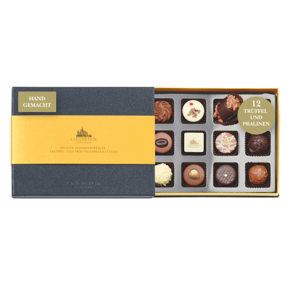 Geöffnete schiefergraue Lauensteiner Pralinenschachtel mit goldener Banderole und zwölf verschiedenen, handgefertigten Pralinen