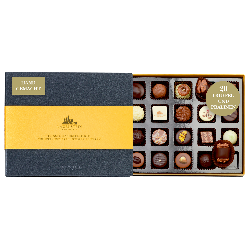Geöffnete schiefergraue Lauensteiner Pralinenschachtel mit goldener Banderole und 20 handgefertigten Pralinen