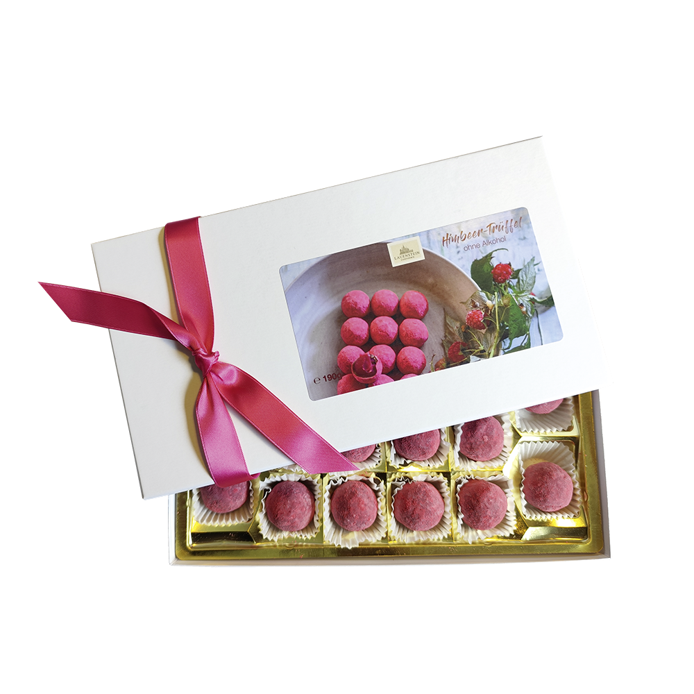 Handgemachte Himbeer-Trüffel in einer eleganten Geschenkbox mit pinker Schleife und 16 runden, pink-gepuderten Pralinen