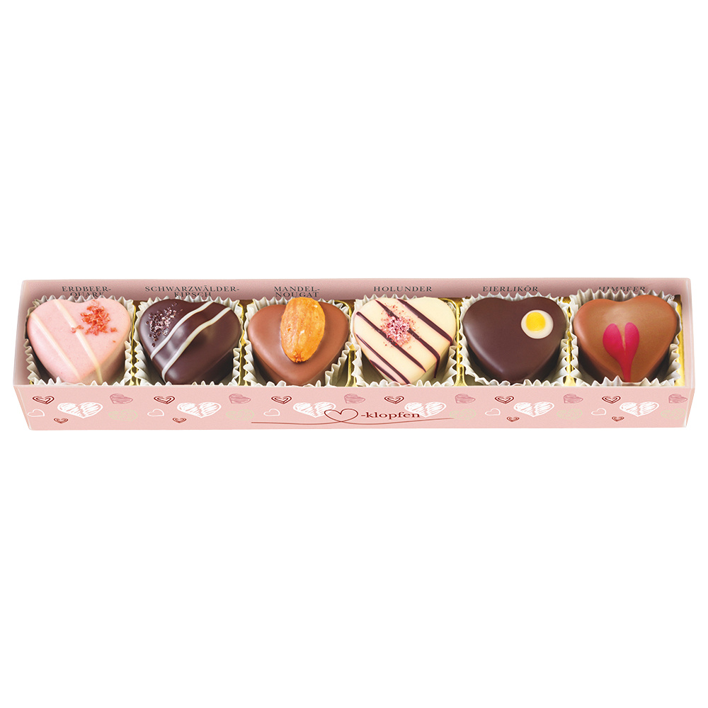 rosa Pralinenstange mit Herzmuster, Klarsichtdeckel und sechs verschiedenen herzförmigen Pralinen
