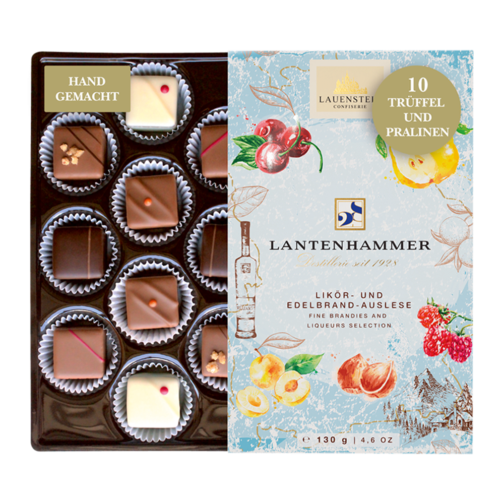 Geöffnete Lauenstein Lantenhammer Pralinenbox mit zehn Likör-Trüffeln und fruchtigen Illustrationen auf der Verpackung