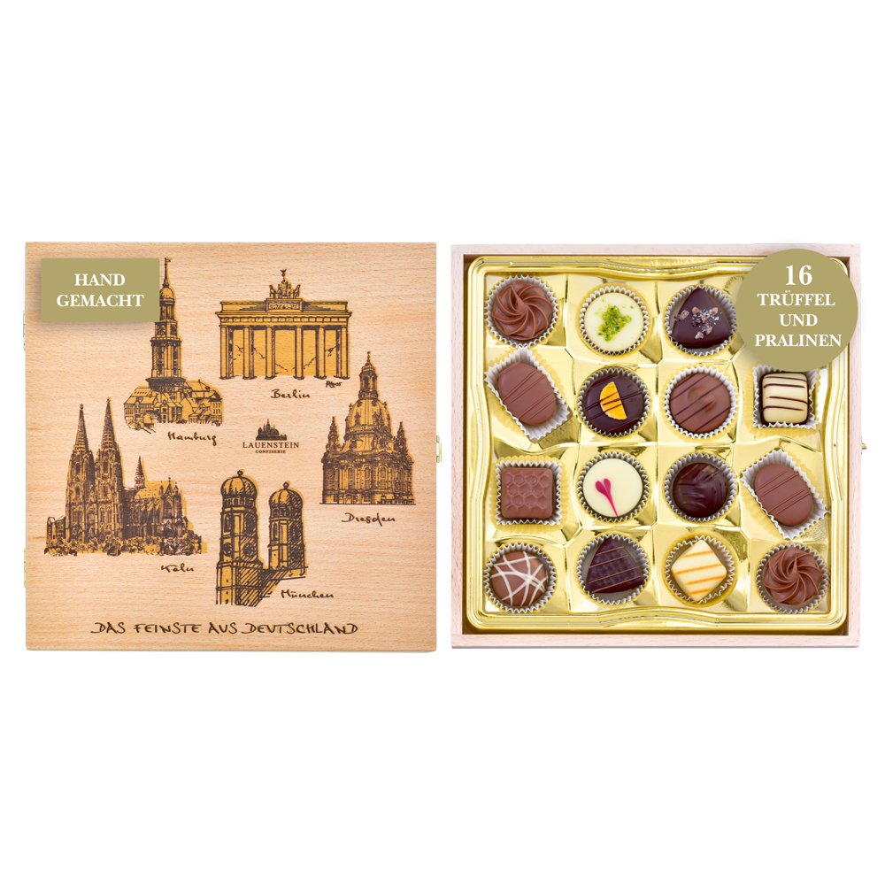 Geöffnetes Holzkästchen mit Grafiken deutscher Sehenswürdigkeiten und 16 handgefertigten Trüffeln und Pralinen von Lauenstein im goldenen Inlay