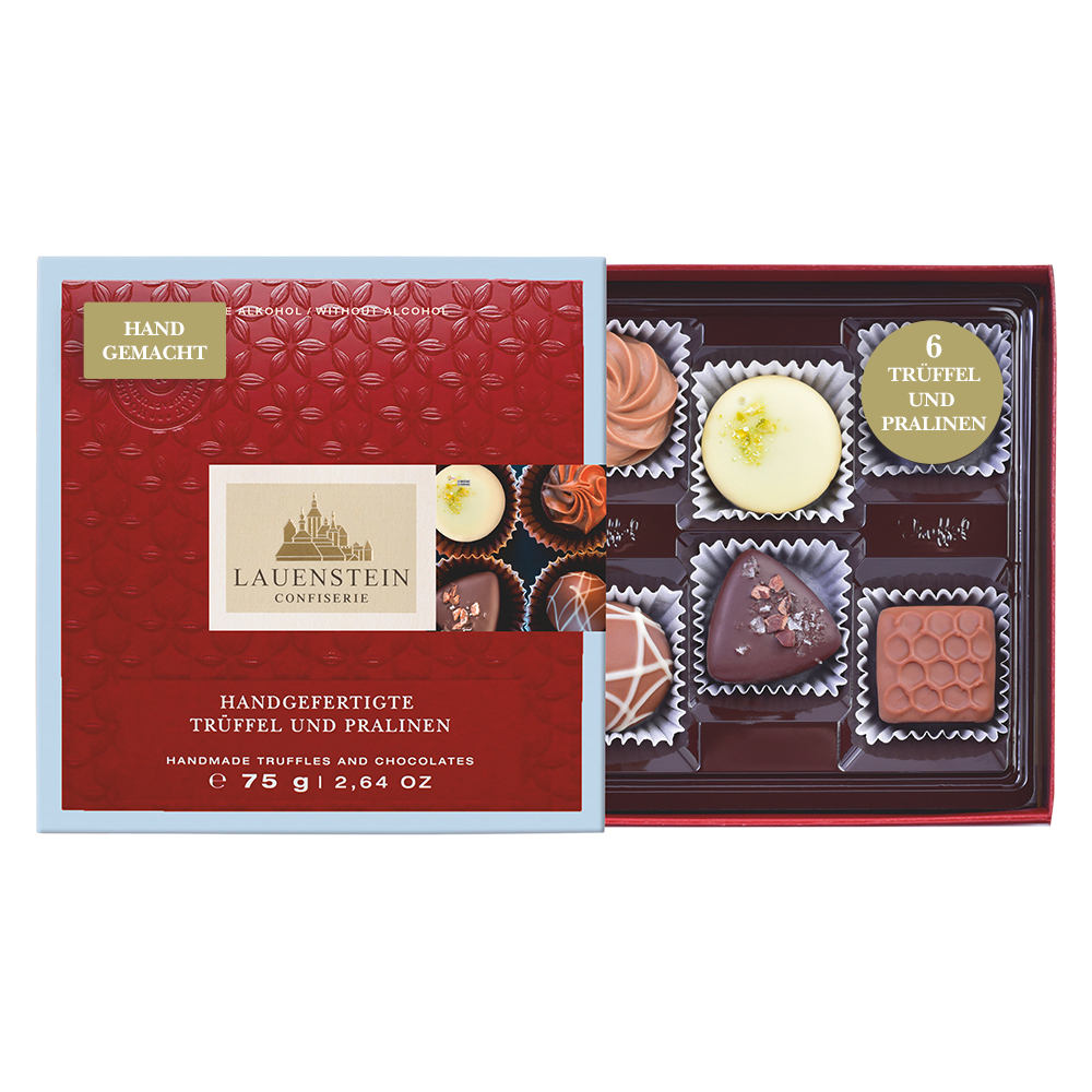 Kleine, geöffnete alkoholfreie Lauensteiner Pralinenschachtel mit hellblauem Rand und sechs Pralinen