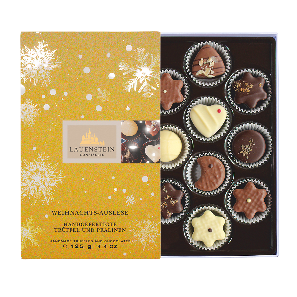 Geöffnete Lauensteiner Weihnachts-Auslese in Gold mit Schneeflocken und 10 weihnachtlichen Pralinen
