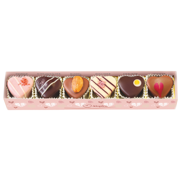 rosa Pralinenstange mit Herzmuster, Klarsichtdeckel und sechs verschiedenen herzförmigen Pralinen