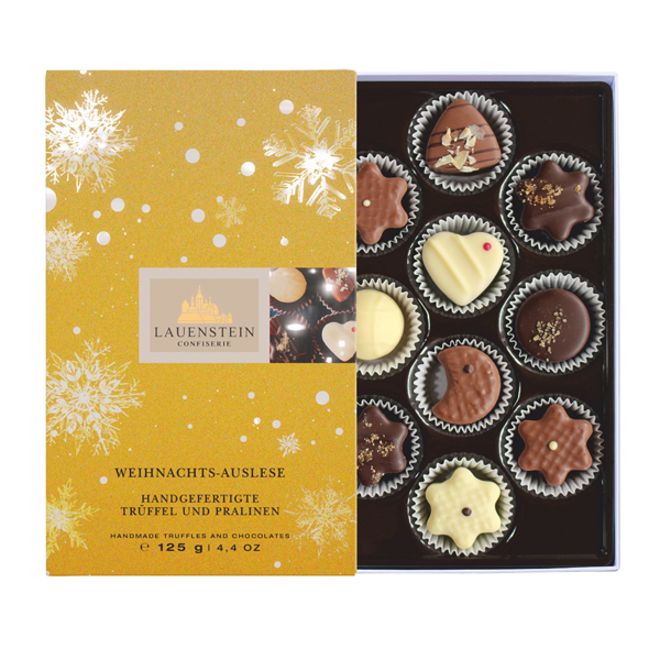 Geöffnete Lauensteiner Weihnachts-Auslese in Gold mit Schneeflocken und 10 weihnachtlichen Pralinen