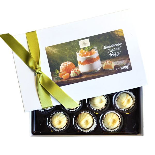 Lauensteiner Mandarine-Joghurt-Gugelhupf in halb geöffneter, weißer Geschenkbox mit grüner Schleife und Produktfoto auf dem Deckel